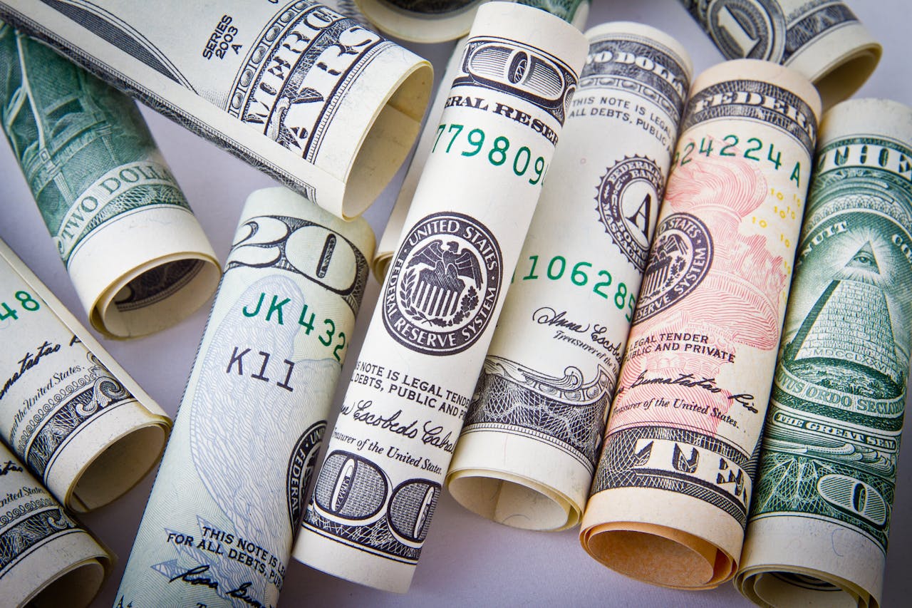 our-journey-01 Close-up of rolled US dollar bills symbolizing wealth, financial success, and currency.